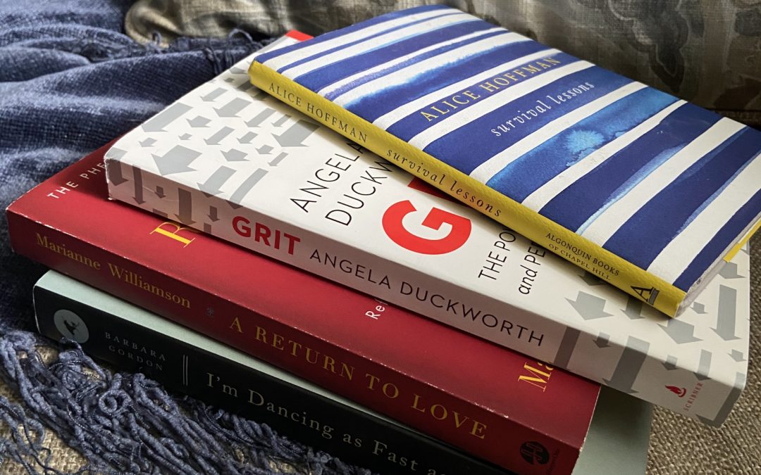 a stack of must-read influential books for women on a cushion.