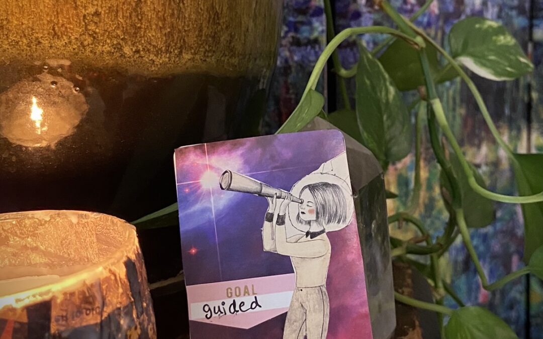 candle and plant surrounds an artist trading card with collage of girl with monocular looking for fulfillment
