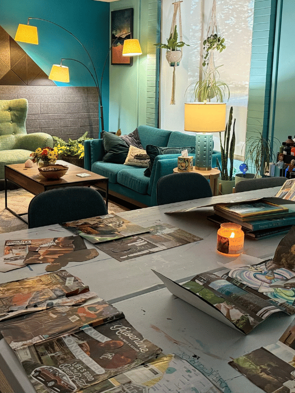Inviting art therapy studio with collage table, soft lighting, and comfortable seating for creative reflection.